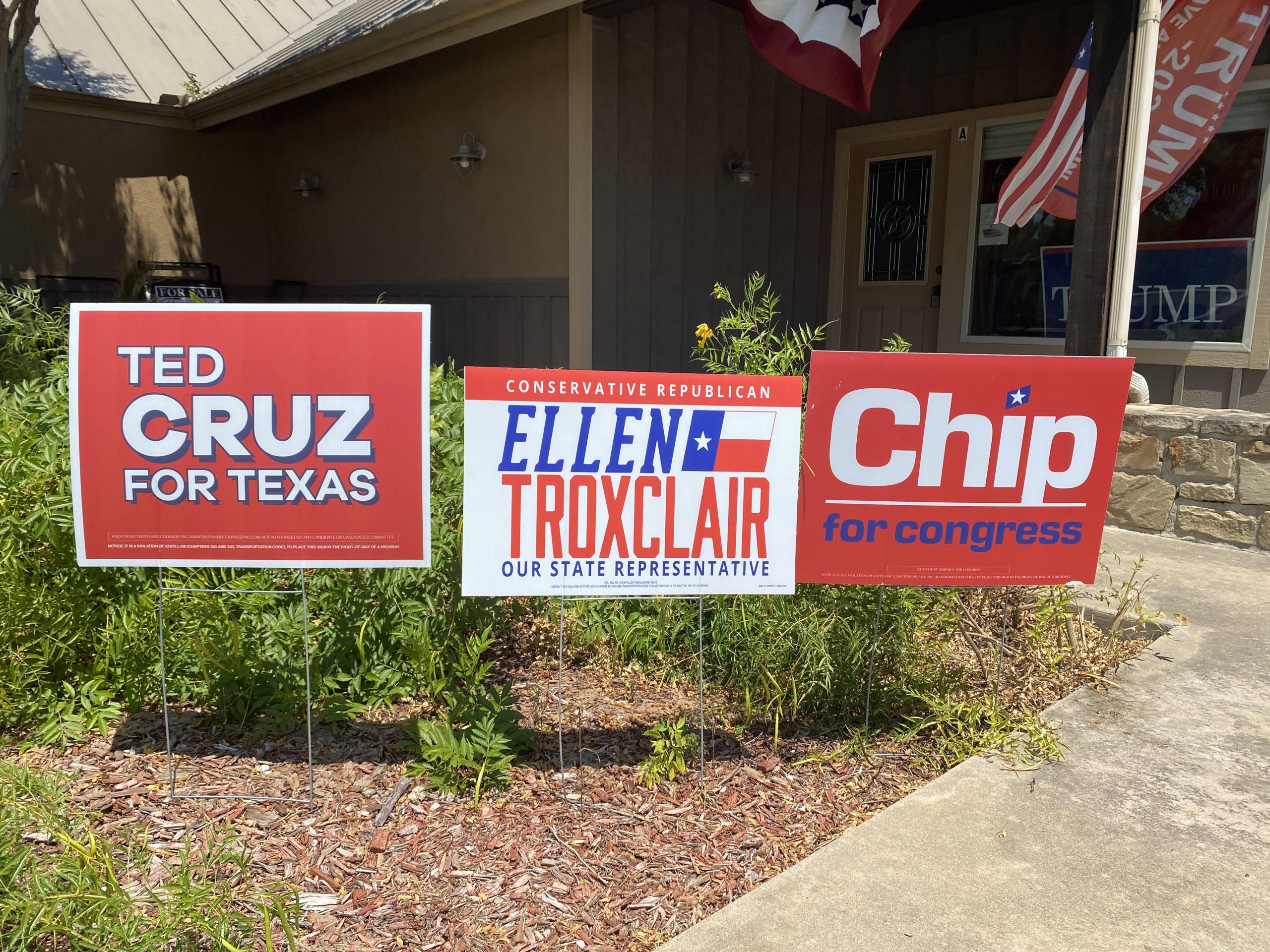 Republican candidate yard signs including Ted Cruz, Ellen Troxclair, and Chip Roy